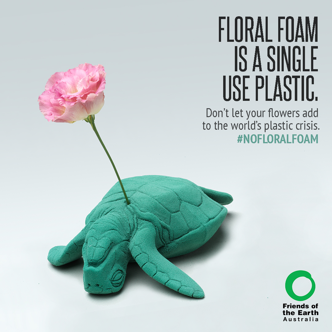 A #nofloralfoam campaign poster showing a dying turtle carved out of floral foam pierced in the heart with a stem of lisianthus.